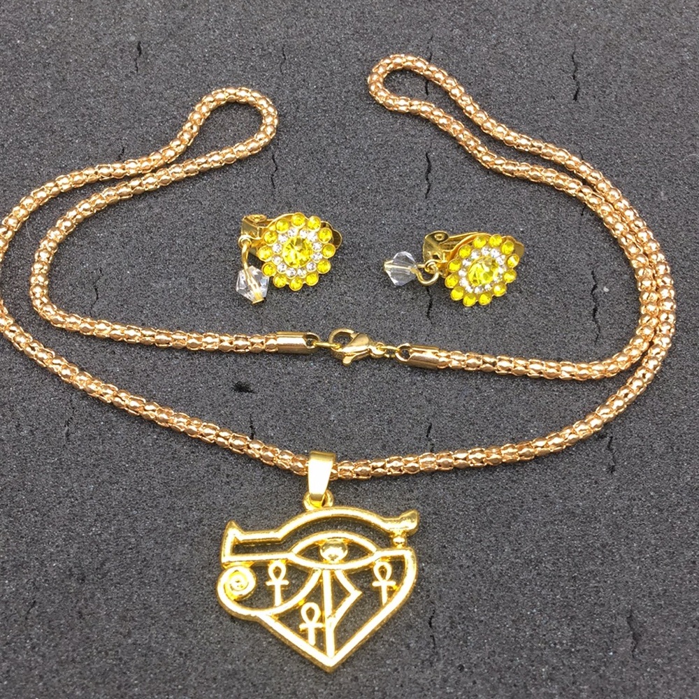 Eye of Horus necklace, rhinestone earrings